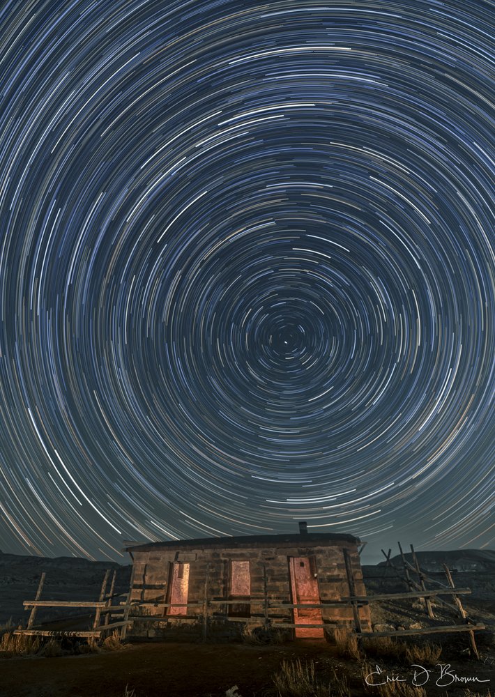 Chasing Star Trails at Skinner Cabin - "Time Spirals Above Skinner Cabin" - A 90-minute exposure captures the mesmerizing rotation of stars creating perfect concentric circles above the historic Skinner Cabin near Grand Junction, Colorado. The warm glow emanating from the cabin windows creates a striking contrast against the cool blues of the night sky, connecting the earthbound structure to the cosmic dance overhead.
