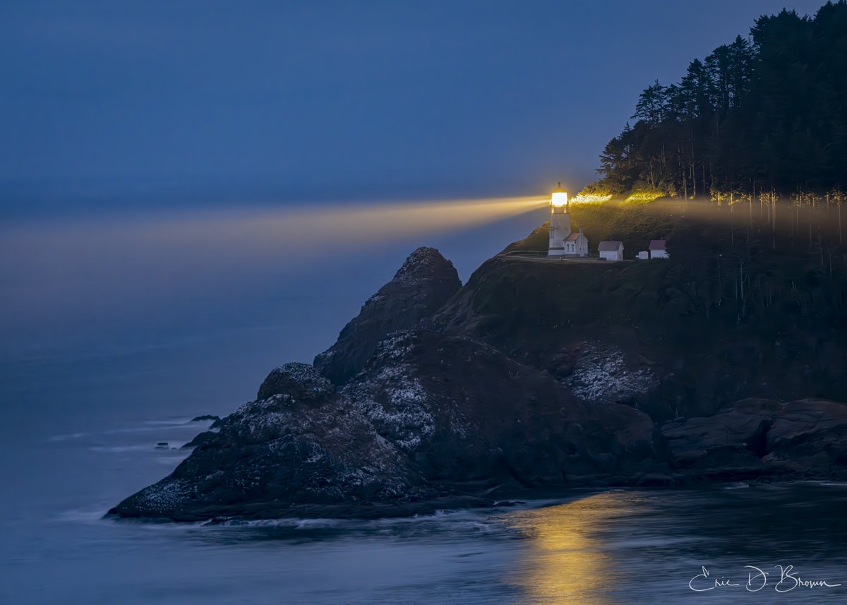 Heceta Head Light Beam -  Heceta Head Lighthouse cuts through coastal fog at blue hour. The original 1894 Fresnel lens still guides ships along the Oregon coast.